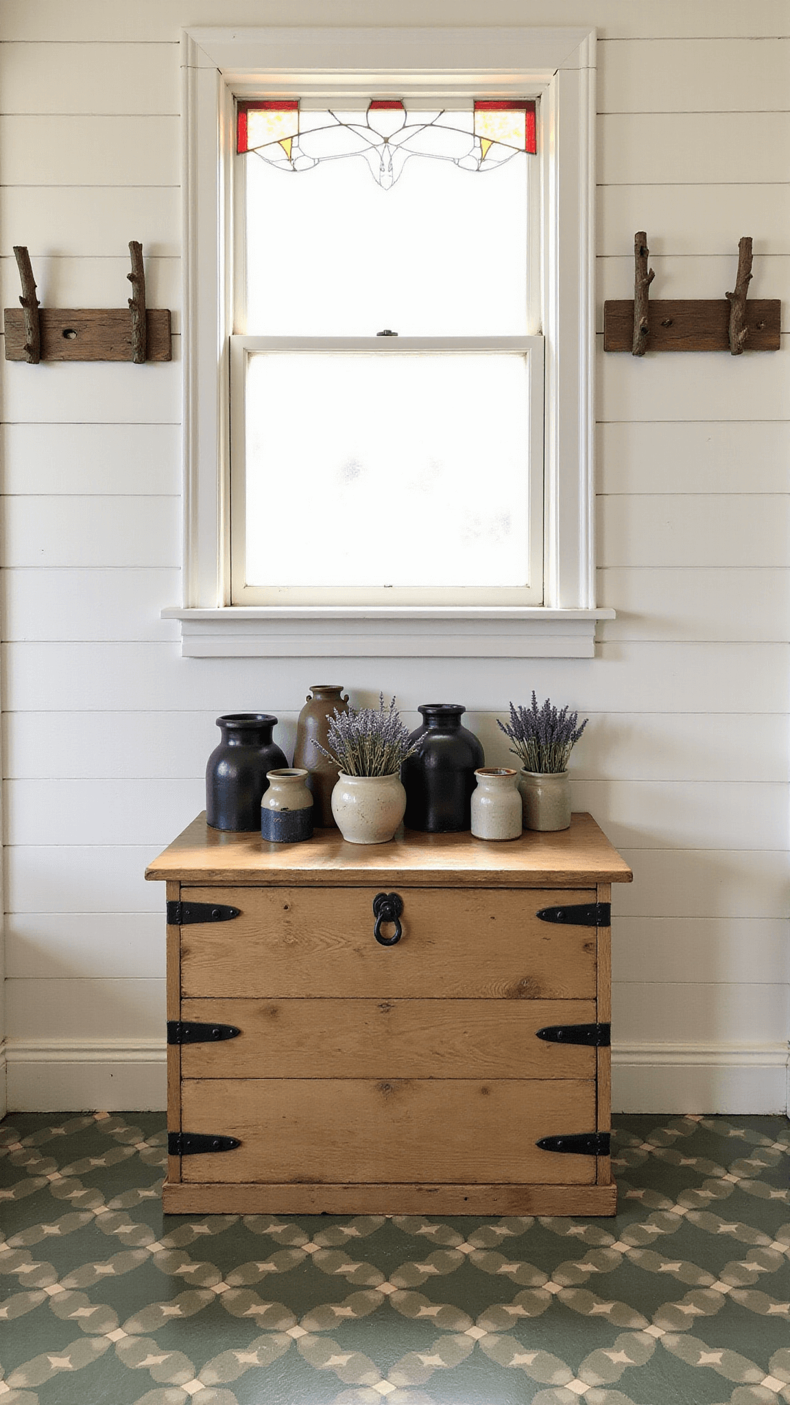 Early morning sunlight filtering through a vintage stained glass window, projecting vibrant patterns onto white shiplap walls, with a rustic wooden chest, vintage crocks with dried lavender, and branch-crafted coat pegs in view, and geometric cement tiles in sage and cream on the floor.